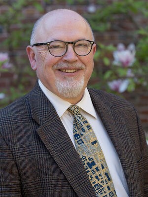 Portrait of Philip Bess in front of a brick wall
